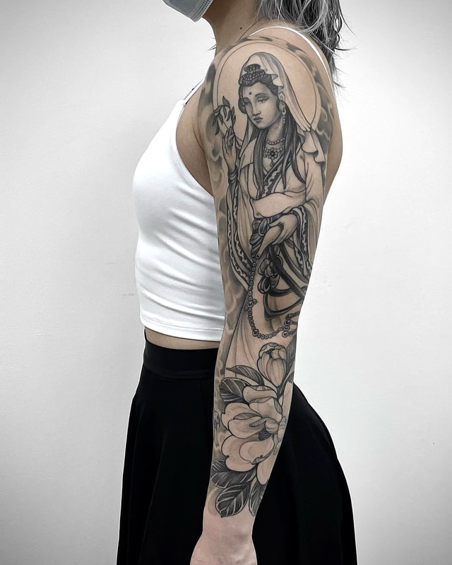 A japanese style tattoo sleeve of the Boddhisatva Guanyin in black and grey