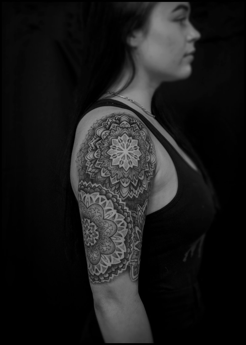 Woman with a geometric half sleeve tattoo