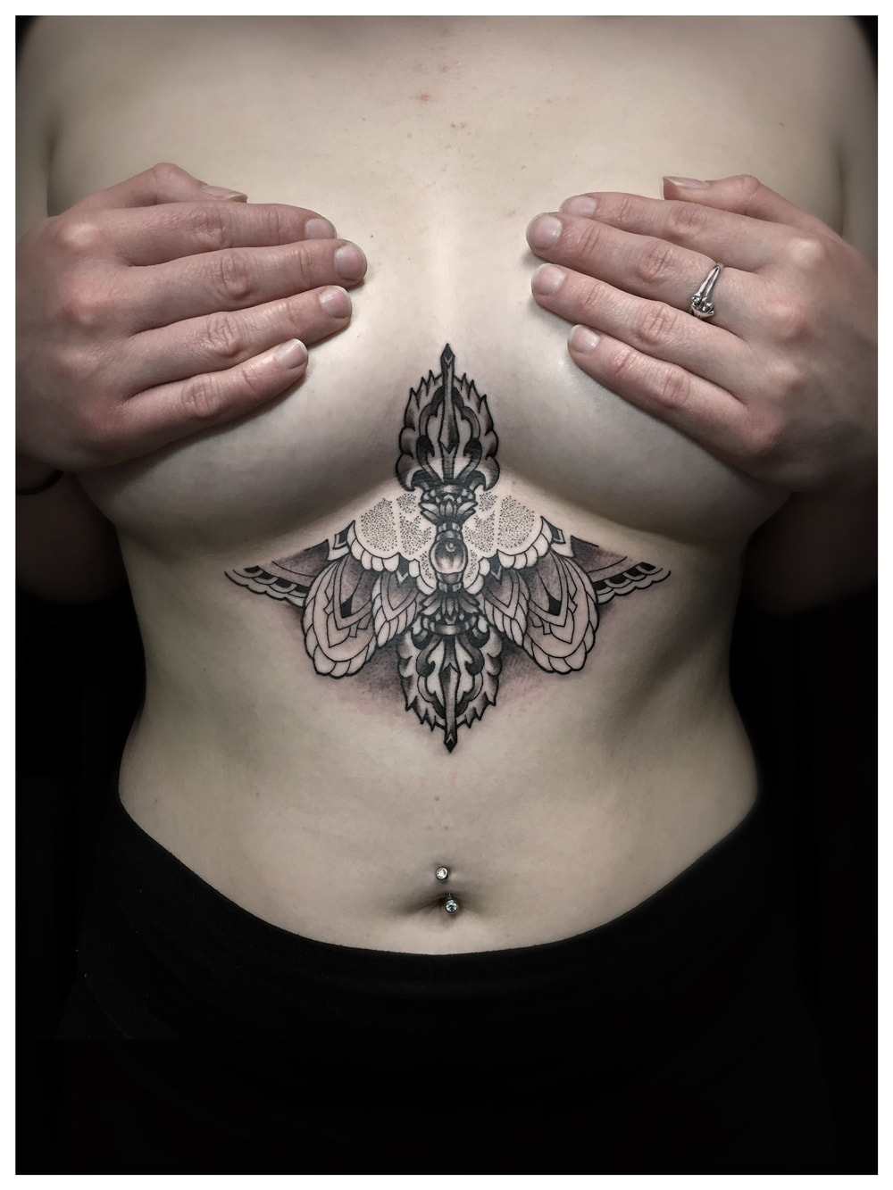 Woman with a sternum tattoo of geometric