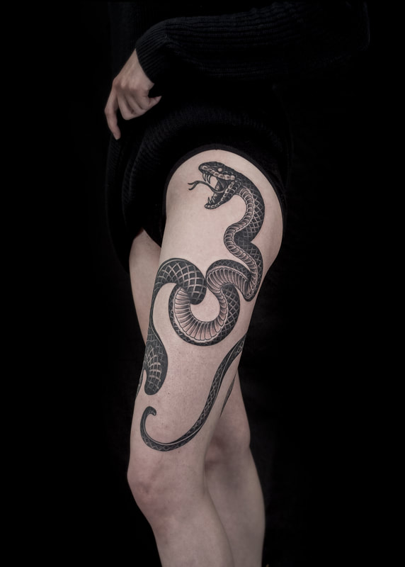 Beautiful snake tattoo around a womans leg