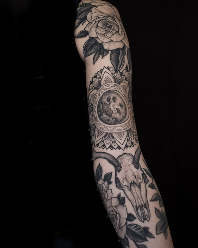 Tattoo by Adam LoRusso artist black and grey boston flowers and skulls sleeve