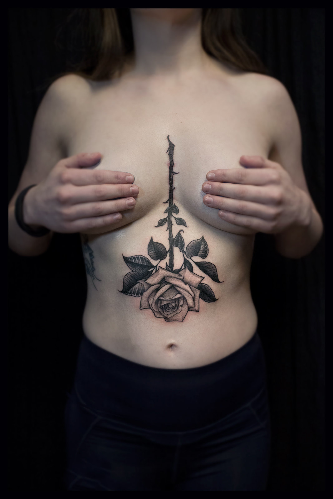Rose tattoo on a womans sternum by Boston artist Adam LoRusso