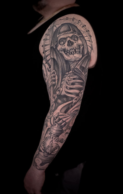 Full sleeve tattoo of a black and gray reaper